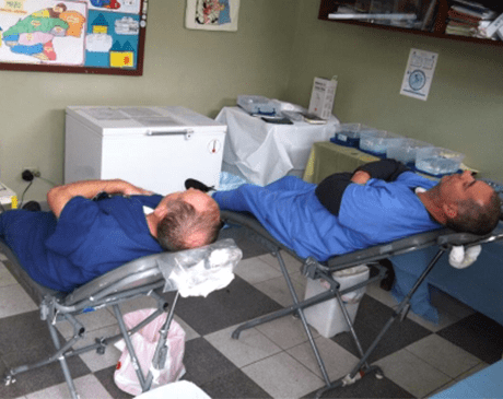Two dentists resting after providing dental treatment on mission trip