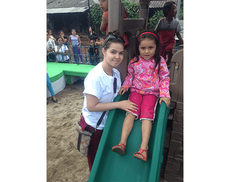 Dental team member and child on a playground