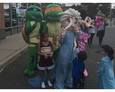 People dressed as cartoon characters at a community event