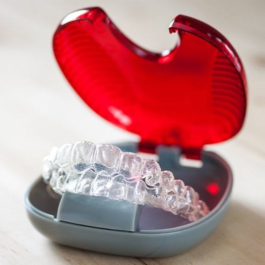 Storage case with two Invisalign clear aligners in Mineola