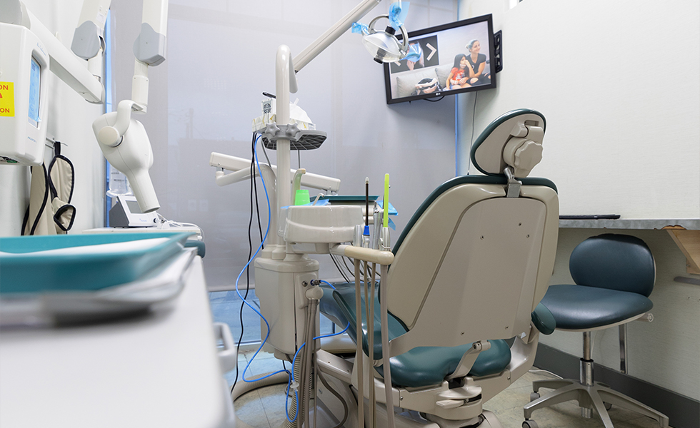 Dental treatment room with T V screen mounted on wall