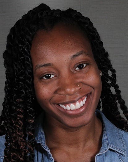 Woman in denim jacket grinning