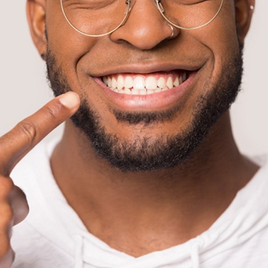 smiling man after understanding the cost of teeth whitening in Plainview