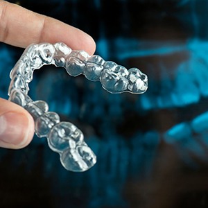 person holding a clear mouthguard 