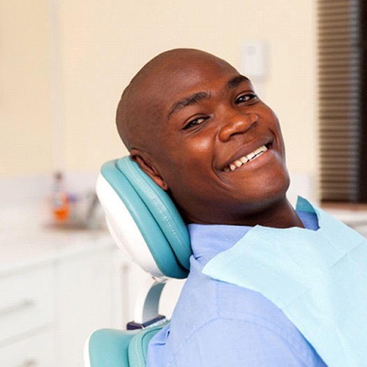 Smiling man leaning back in dental chair