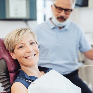 Smiling woman leaning back in dental chair