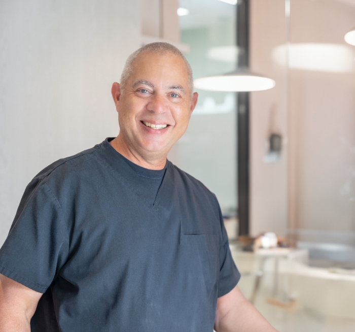 Smiling Mineola New York dentist in dental office