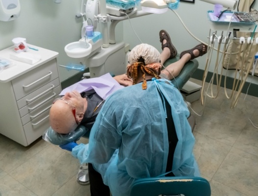 Man with complete smile after replacing missing teeth with dental implants