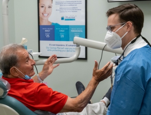 Smiling woman with a dental implant supported denture