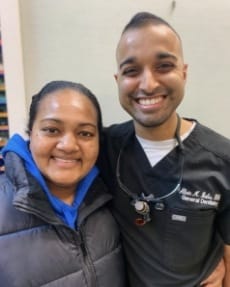 Dentist and patient smiling after dental visit