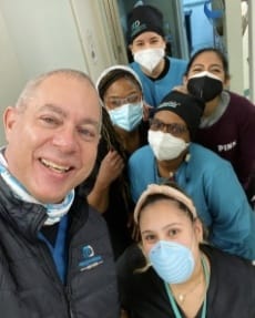 Dentist and team member taking photo in dental office