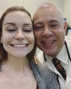 Dentist smiling with dental patient after her treatment visit