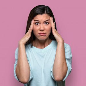 Woman rubbing her head and looking stressed