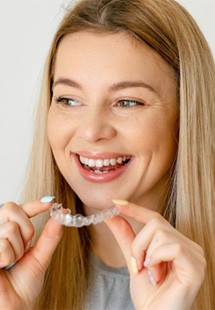a woman smiling with Invisalign aligners near Garden City