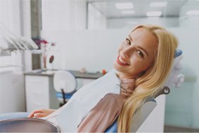 Smiling blonde woman in dental chair