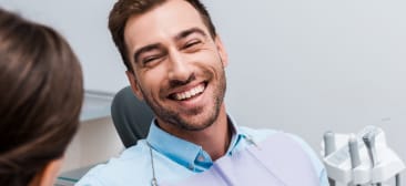Man laughing during preventive dentistry visit