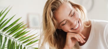 Woman in white sweater smiling