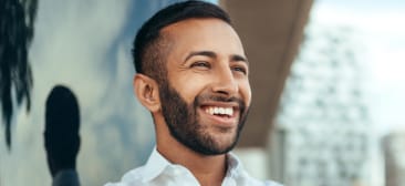 Man with perfectly aligned smile after Invisalign clear braces