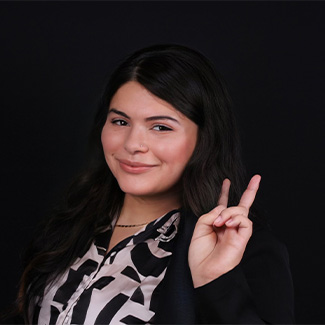 Receptionist Arasely giving peace sign