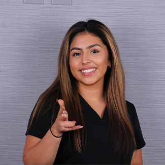 Dental Assistant Estefany making finger gun sign with her hand