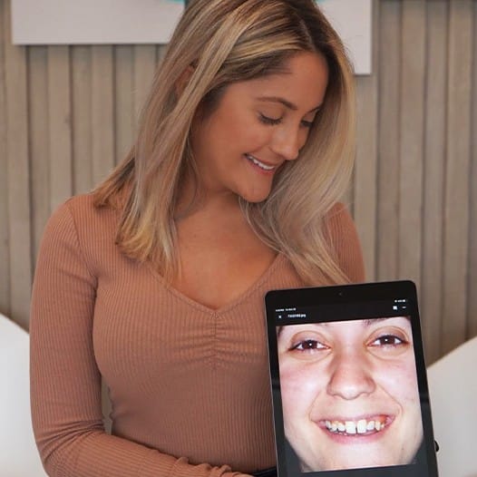 Woman looking at her digital smile design on chairside computer