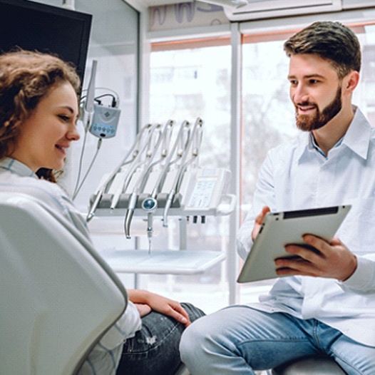 Dentist showing a tablet to a patient