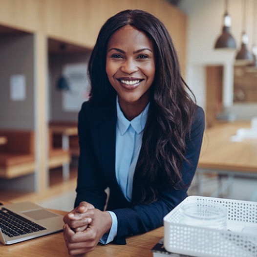 Smiling businesswoman sitting at table