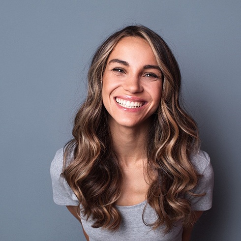 woman smiling after getting veneers in Mineola