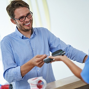 Man swiping his payment card at front desk