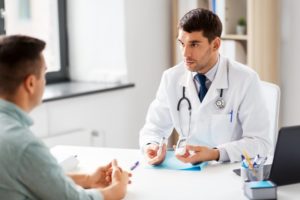 dentist talking to a diabetic patient about dental implants