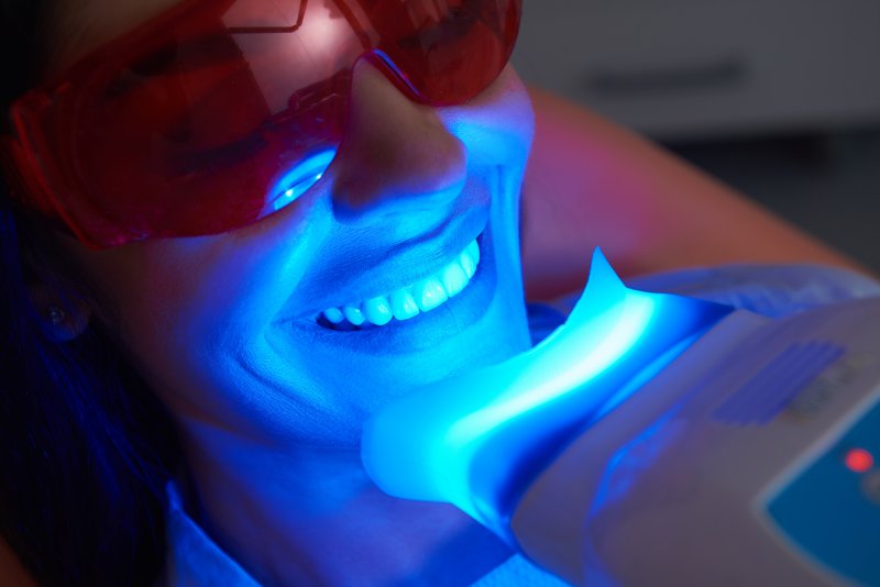 A patient whitening their bonded teeth