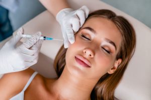Woman with brown hair getting BOTOX injection